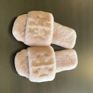 Tory Burch pink shearling slippers.